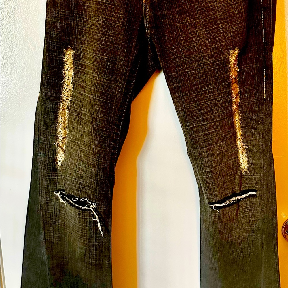 True Religion vintage women’s distressed jeans with holes made by the designer.